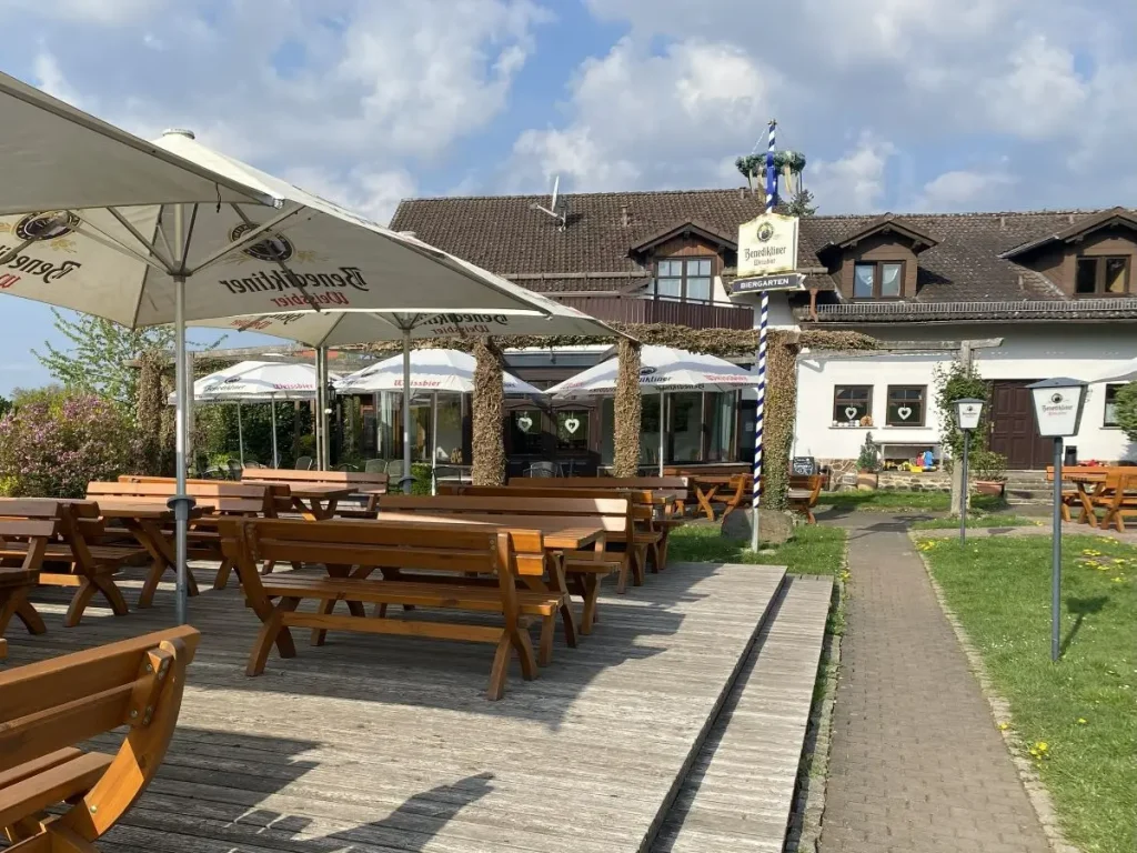 Biergarten des Berghotels Stornfels mit großzügiger Terrasse, Sitzbereichen im Freien und Blick auf die umliegende Landschaft des Vogelsbergs